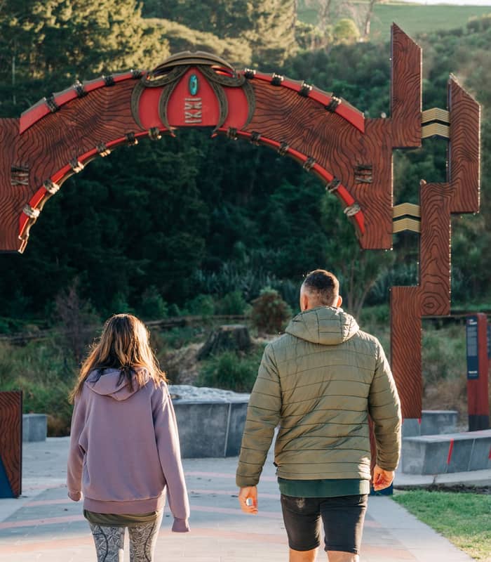 Couple walking into Papamoa Hills park.
