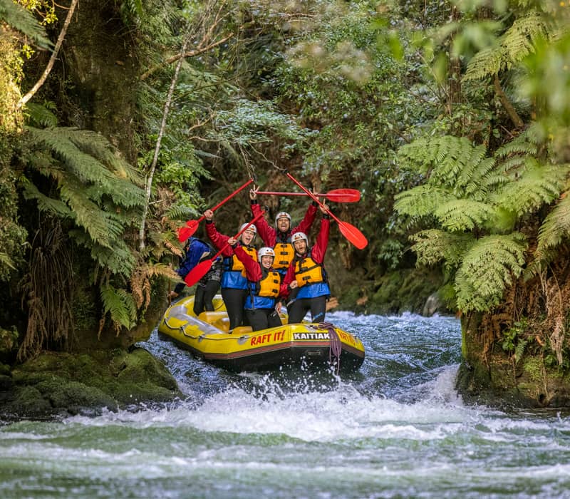 People rafting down river with Kaitiaki Adventures