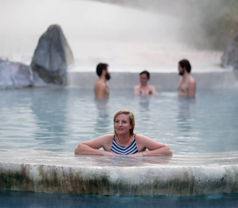 Woman relaxing in Wairakei Terraces Pools in Taupo.